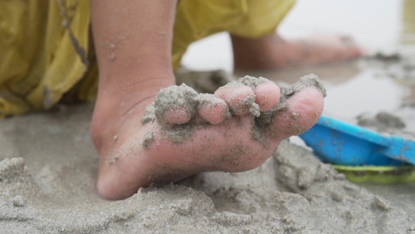 Barefoot of little girl on beach
