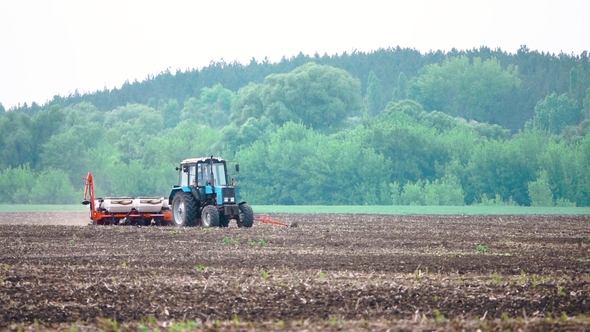 Tractor Works Plows the Field Before Planting the Harvest alt