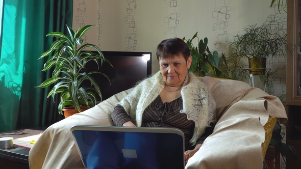 Elderly Woman Sitting at the Laptop