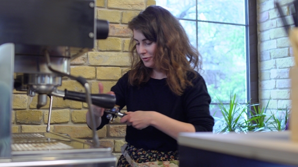 Barista Tamping Grinded Coffee inside of Portafilter