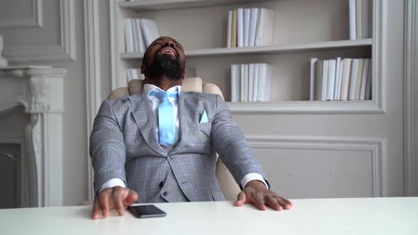 Unhappy Businessman Is Crying and Shouting in His Office, Sitting at Table and Feeling Bad