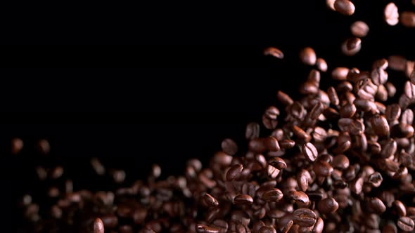 Super Slow Motion Shot of Exploding Premium Coffee Beans Isolated on Black at 1000Fps