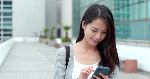 Businesswoman check on smart phone in city