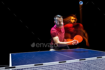 s man tennis-player in play on black background with lights. Movement, sport game, stobe concepts. Professional. Human emotions, facial expression