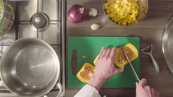 Chef's Hands Cutting Out Pumpkin Seeds