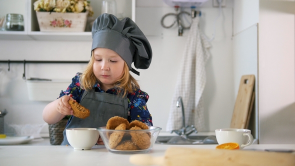 Preschool Girl Eats Cookies Prepared with Her Own Hands