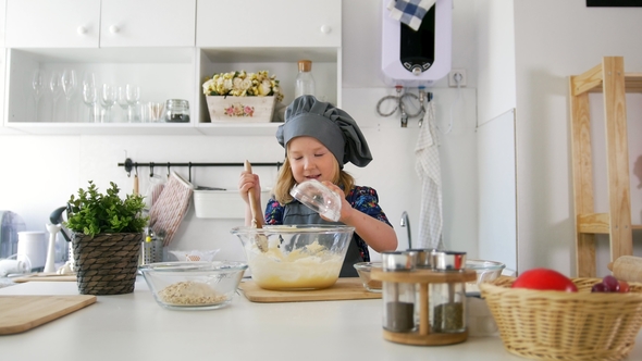 Little Girl Adds Oatmeal to the Pastry Dough