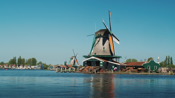 Picturesque Landscape of Rural Holland. A Traditional Old Windmill Near the River.