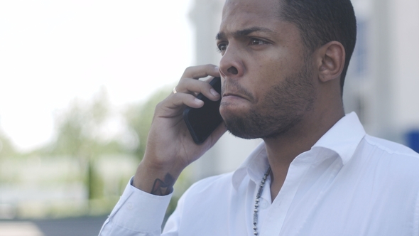 African American Man Aggressively Communicates By Phone