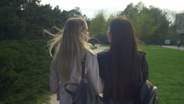 Pretty Multiracial Girls Turning Back Smiling in Park