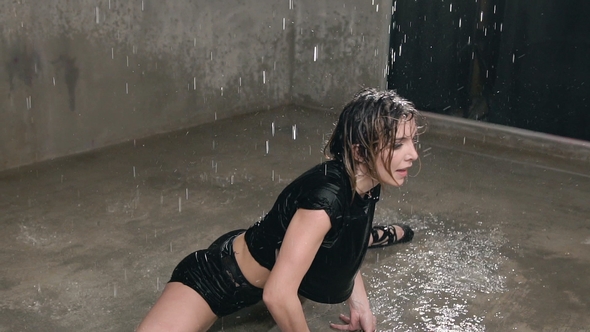 Wet Woman Dancer in Black Body Suit and Points Performs Modern Dance on the Floor in the Rain 