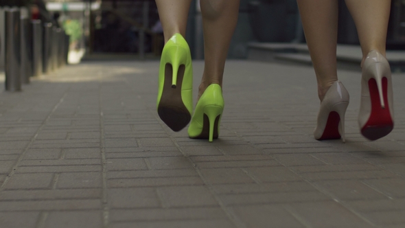 Elegant Women in High Heels Taking a Walk on Street