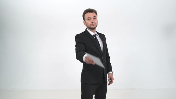 Businessman Holds Out a White Envelope with Money