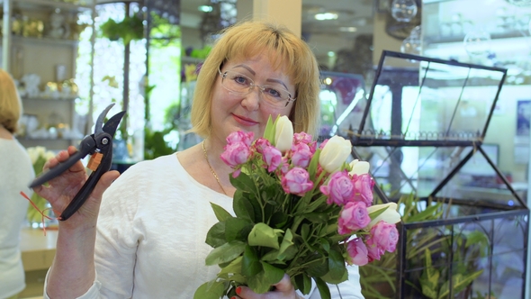 Smiling Mature Woman with Bouquet of Roses and Tulips