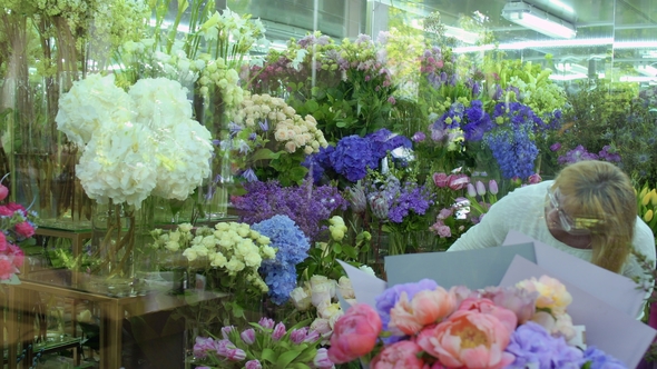 Mature Woman Choose Flowers in Flower Shop