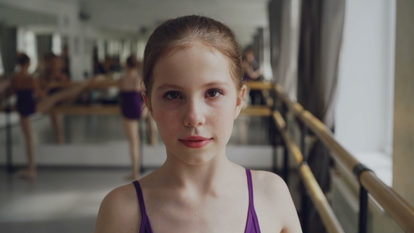 Portrait of Young Girl Starting Ballet-dancer with Make-up Looking at Camera and Smiling