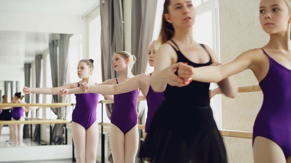 Starting Ballet Dancers Are Practising Arm Movements During Ballet Class in Studio