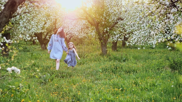 Mum with Daughter Walk Together on Nature