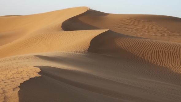Sand Blowing over Dunes in Wind at Sahara Desert