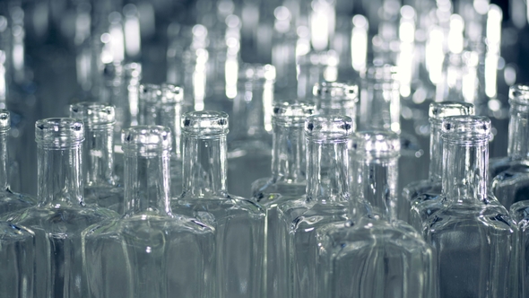 A Pile of Empty Glass Bottles Is Moving Forwards and Sideways