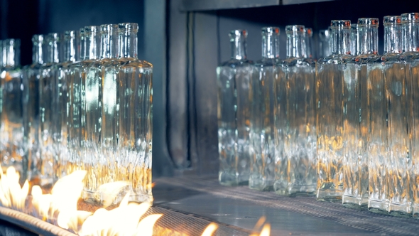 Annealing Process of Glass Bottles with Them Being Removed From the Conveyor Afterwards