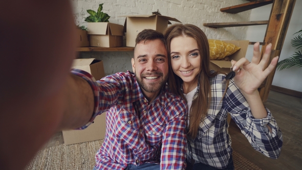 Happy Couple Taking Selfie with House Keys After Purchasing New Apartment