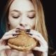 The Hamburger Is in the Hands of the Girl. Delicious Fast Food. The Cheeseburger Smells. The Thin - VideoHive Item for Sale