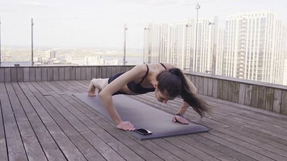 Woman Fitness Push-Ups at Roof Terrace