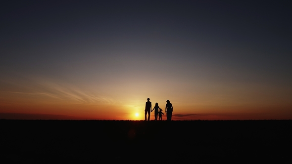 Silhouette at Sunset Happy Family Walking