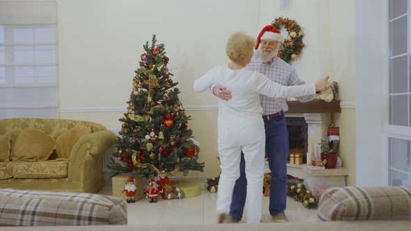 Senior Couple Dancing Near Christmas Tree
