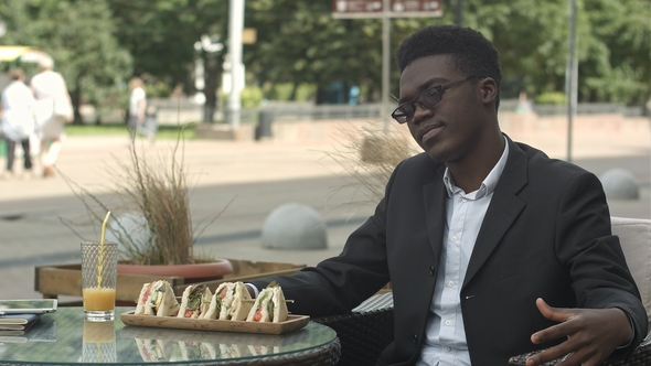 Tired Afro-american Businessman Sitting in Cafe Looking Bored or Fed Up