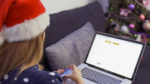 Young Girl Makes Christmas Shopping at Home