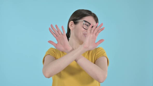 Young Woman Saying No By Hand Gesture on Purple Background 