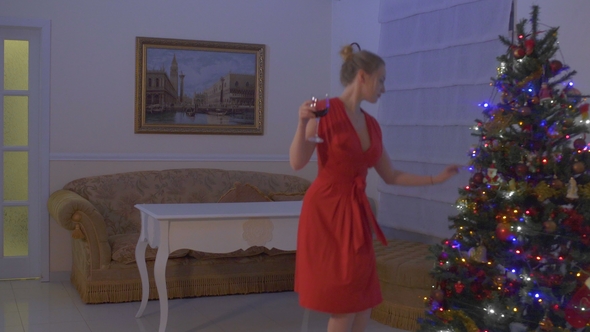Confident and Beautiful Woman in Red Dress Celebrate Christmas Alone at Home