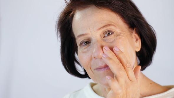 Middle-aged Woman Applying Cream