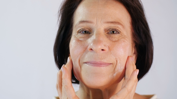 Smiling Woman Applying Cream