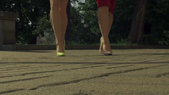 Elegant Female Legs in High Heels Walking on Street