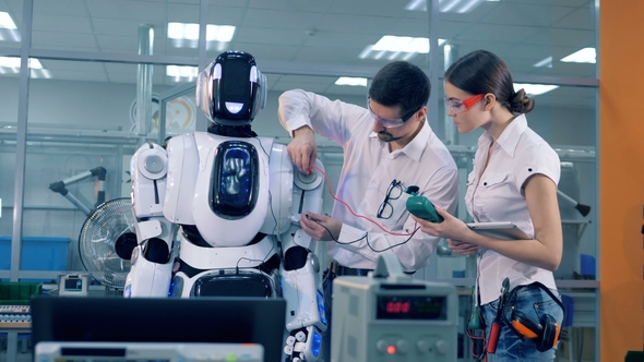 Two Engineers Are Measuring Technical Parameters of a Robot