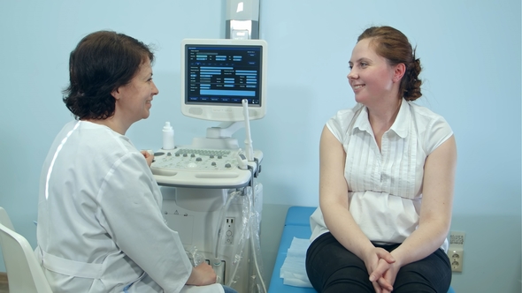 Smiling Woman Patient Having Consultation with Female Doctor