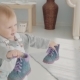 Little Lovely Girl Takes Her Shoes. Happy Beautiful Baby Gives Her Shoes To Her Mom. - VideoHive Item for Sale