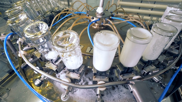 A Mechanism Washes Bottles at a Plant
