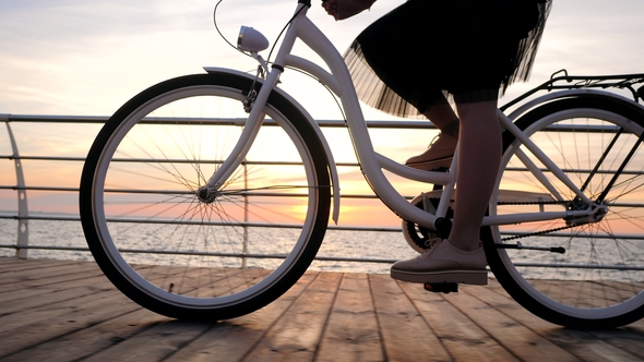 View of Young Stylish Girl in Pink Platform Shoes Brogues and Skirt Cycling on Vintage Bike