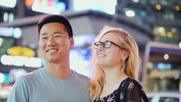 A Young Couple Admiring the Lights of Advertising at the Famous Times Square in New York