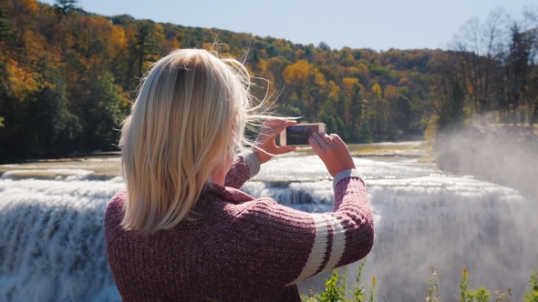 A Tourist Takes Pictures of a Beautiful Waterfall in Letchworth State Park