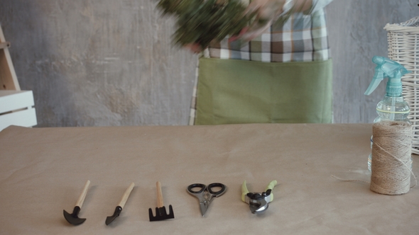 Florist's Hands Laying out Flowers on the Table