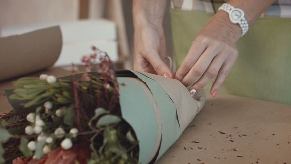 Florist Packing Festive Bouquet in Wrapping Paper