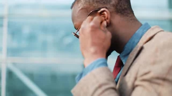 African American Businessman Listens To the Music and Dances While He Walks Near the Office Building