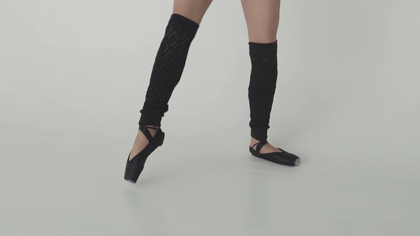 Feet Ballerina . Ballet Dancer in Black Leggings and Pointe Shoes