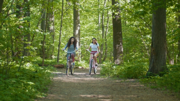 Cycling Walk in the Park Two Cyclists Famale, Sunny Day