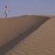 Girl Teenager Runs Around the Sand on the Slope of the Dune in Rub Al Khali Desert United Arab - VideoHive Item for Sale